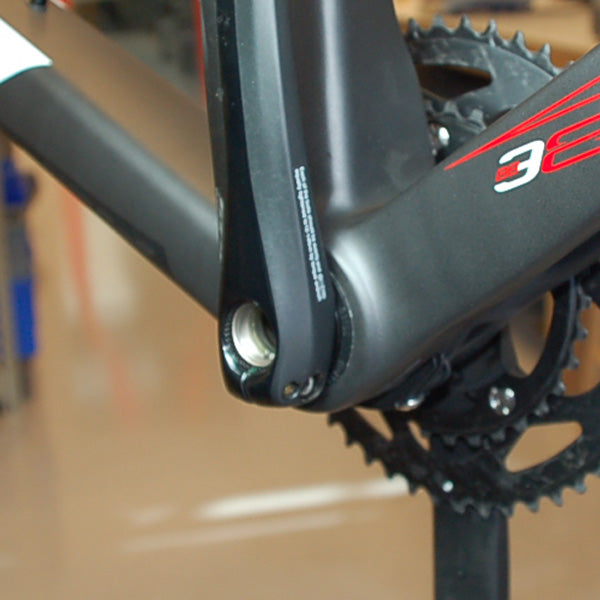 Attach left crank arm. Use spacers if needed.