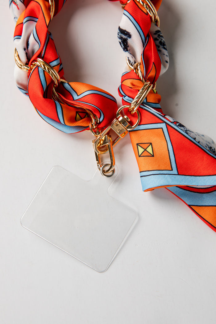 Phone case with a orange and white scarf accessory on a white background