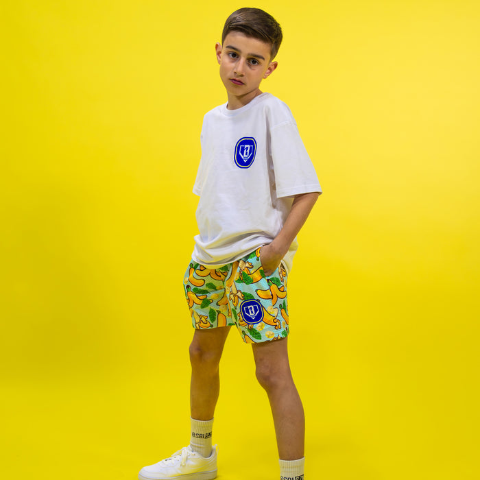 Youth model wearing yellow Banana Tropical youth shorts