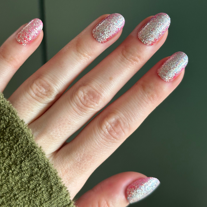 Hand displaying Cherry Super Sparkle - Press On | Short | Round with candy cherry-pink glitter press-on manicure nails