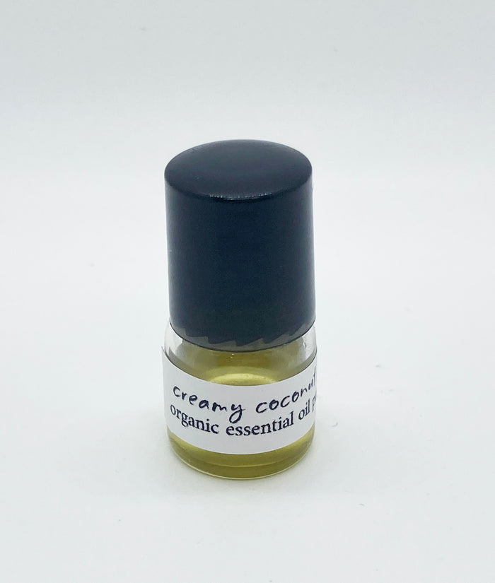 1ml sample bottle of Creamy Coconut Lime organic essential oil perfume with a black cap, shown against a white background.