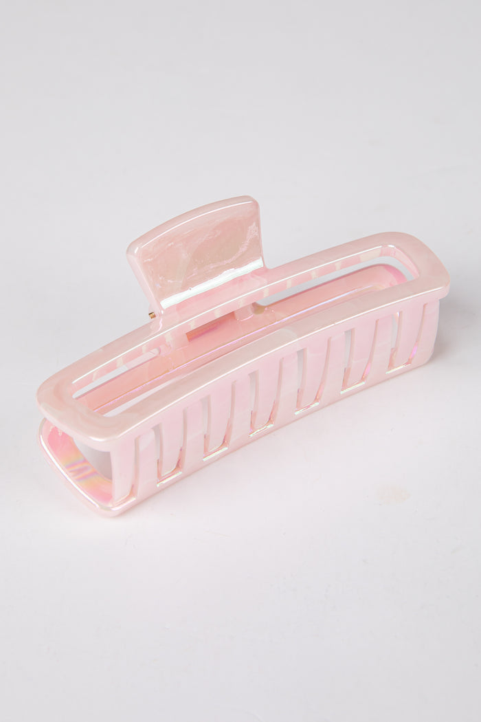 Pink hair clip on a light gray background