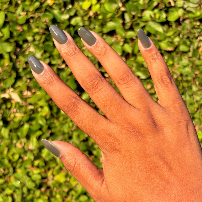 Is It Smoky In Here? Gel polish on long natural nails in deep charcoal gray for an elegant at-home manicure by Olive and June