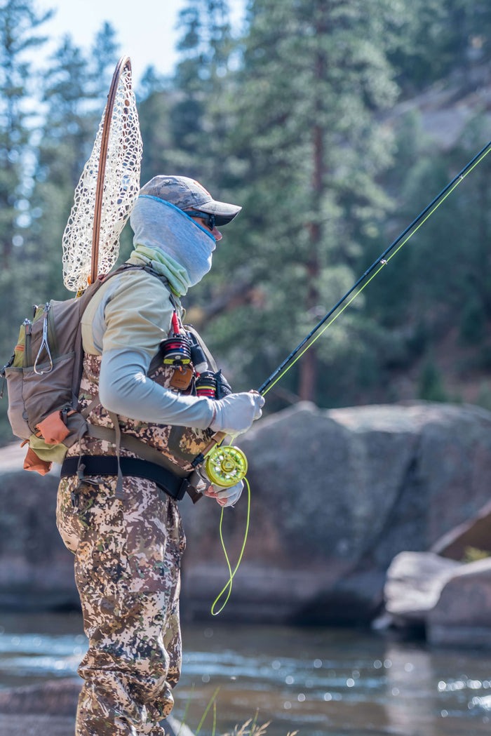 Side view of someone fly fishing