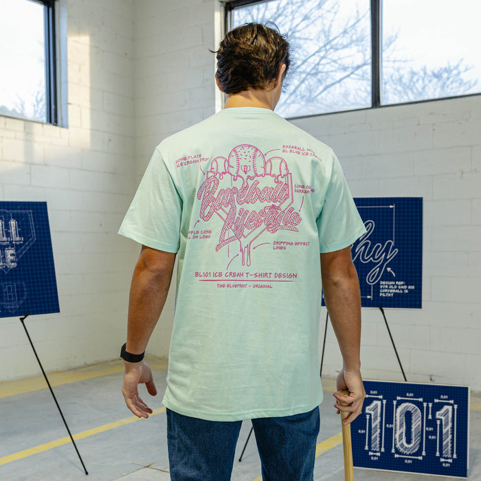 Person wearing a light blue t-shirt with pink ice cream graphic and "Baseball Lifestyle 101" logo