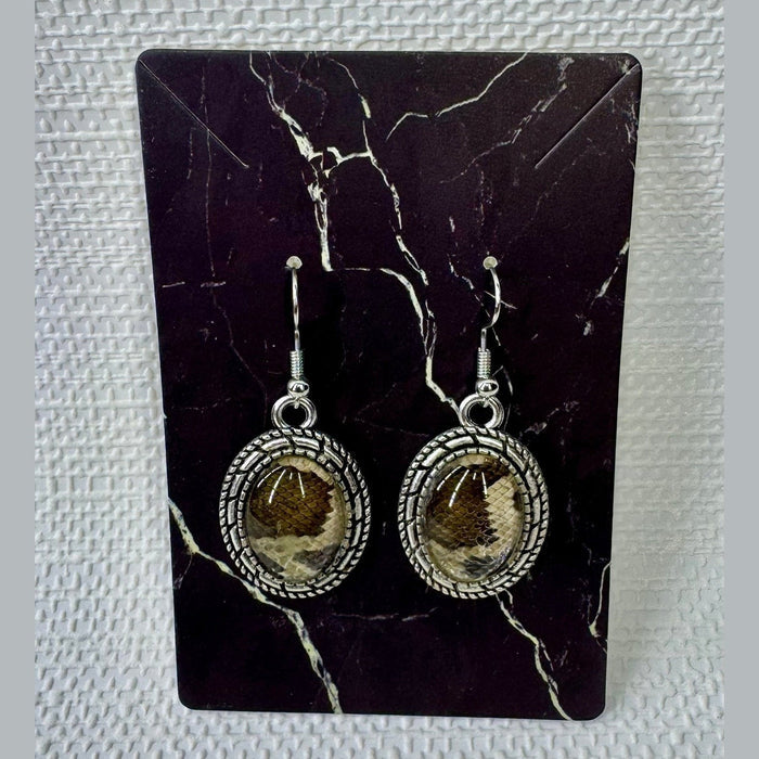 Fort Denaud Beard and Skin oval drop earrings featuring a textured silver rope frame and a snakeskin pattern inlay.