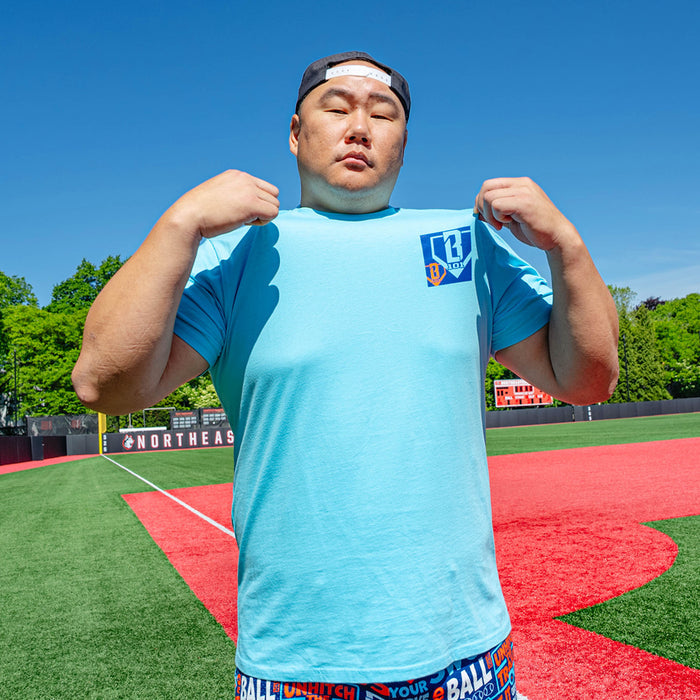 Adult model wearing blue graphic tee with "Trash Talk" design