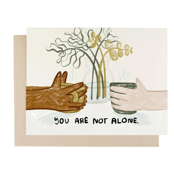 Greeting card with illustrated hands, flowers, and message "You are not alone"