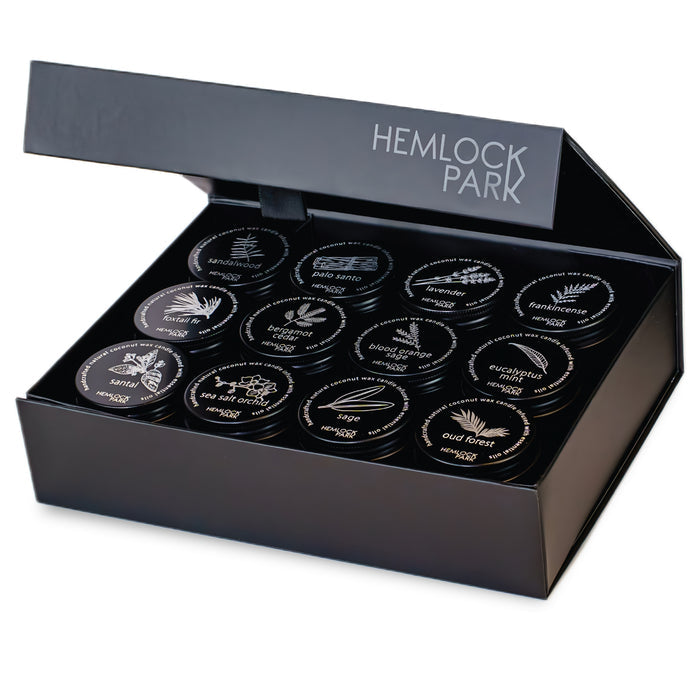 Tea-light scent set: open black box of 30 labeled tins, HEMLOCK PARK