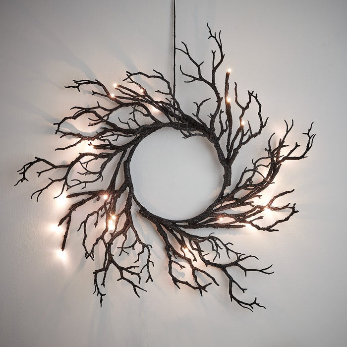 HA23002_Lit-Halloween-Prelit-Twig-Wreath-Hanging-On-Wall.jpg