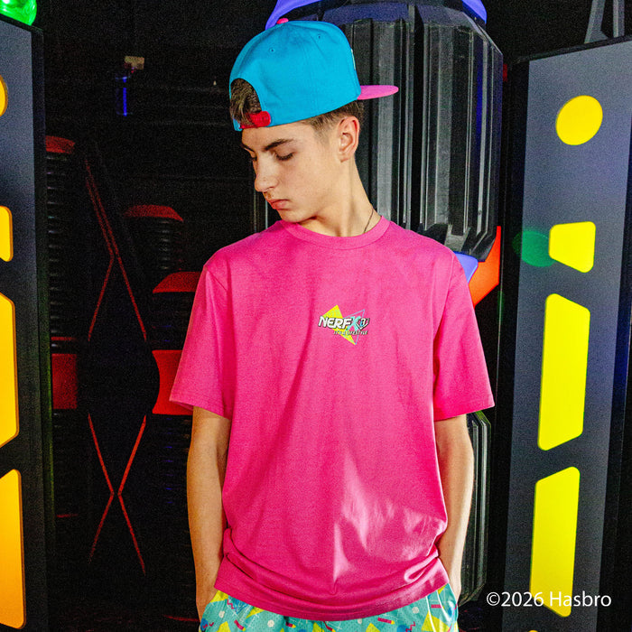 Person wearing a pink shirt with a 'NERF X BL101' logo and colorful shorts, standing in front of a vibrant, abstract background.