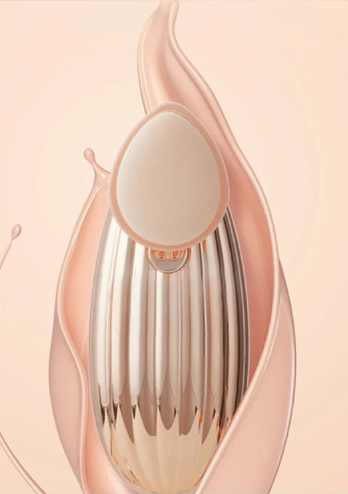 Rose gold and silver makeup tool on a soft pink background