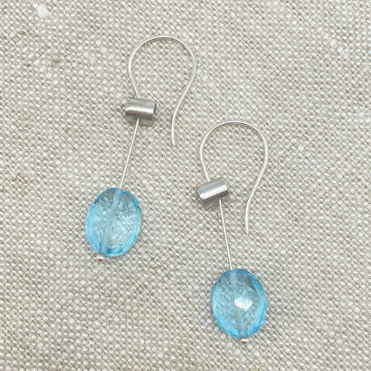 Silver-tone pivot drop earrings with oval blue topaz gemstones