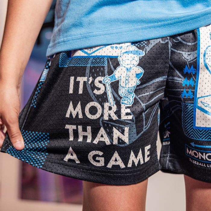 Youth model wearing youth shorts with “Boardwalk Slugger” design