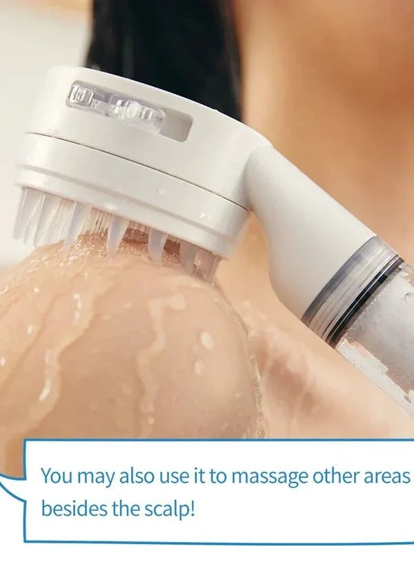 A close-up of a white handheld scalp massager being used on wet skin, with a text overlay that says 'You may also use it to massage other areas besides the scalp!'.