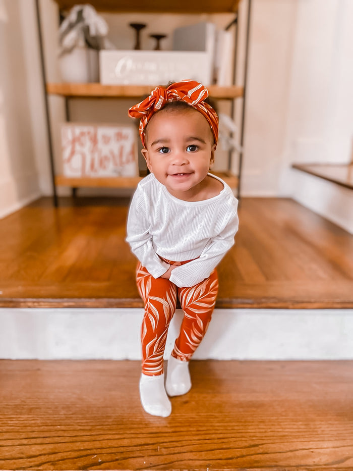 Toddler girl in Burnt Orange Pampas Leaves Leggings