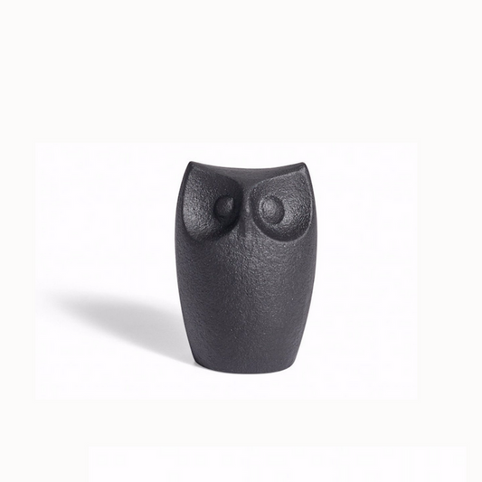 Cast iron horned owl figurine with textured dark finish, rounded body and carved eyes