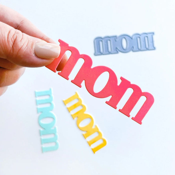 Catherine Pooler - Word Die - Just Mom. Send a card to your favorite mom!  The Just Mom Word Die is a simple block font "mom" that will be a cute addition to any card for mother's day or any day celebrating your best lady! Take the "m" and cut one hump off to create "mum"!  The Mom Word Die measures approx. 3" x 1".  Illustrated by Lisa Kirkbride. Available at Embellish Away located in Bowmanville Ontario Canada.