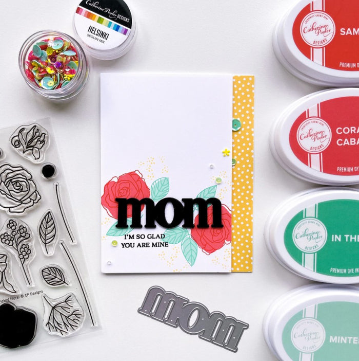 Catherine Pooler - Word Die - Just Mom. Send a card to your favorite mom!  The Just Mom Word Die is a simple block font "mom" that will be a cute addition to any card for mother's day or any day celebrating your best lady! Take the "m" and cut one hump off to create "mum"!  The Mom Word Die measures approx. 3" x 1".  Illustrated by Lisa Kirkbride. Available at Embellish Away located in Bowmanville Ontario Canada. Card by brand ambassador.