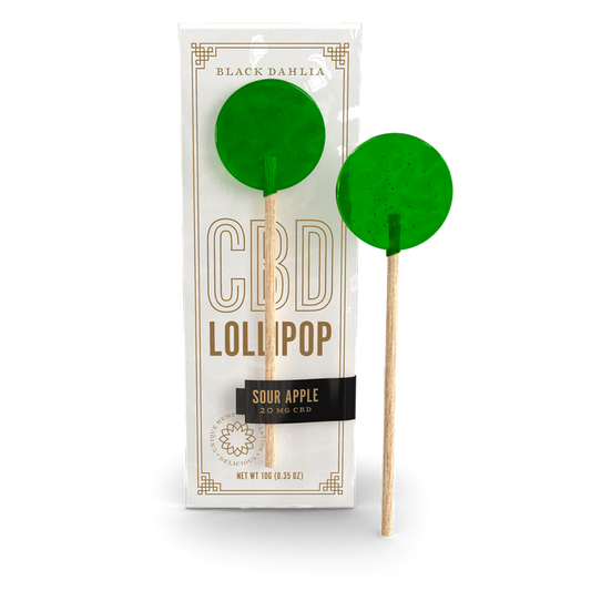 CBD sour apple lollipop with green candy on wooden stick, shown in wrapper