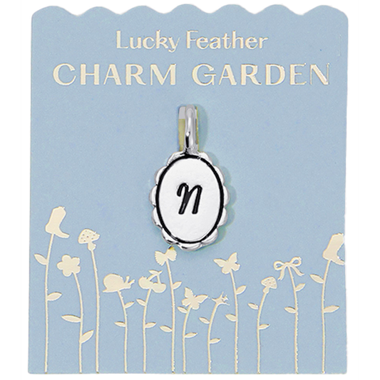 Silver scalloped initial charm with the letter N from Lucky Feather's Charm Garden collection, featuring a detailed, decorative design.