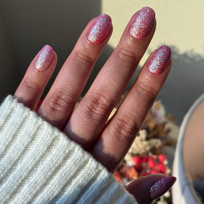 Hand showing Cherry Super Sparkle - Press On | Short | Round candy pink glitter packed press-on manicure nails