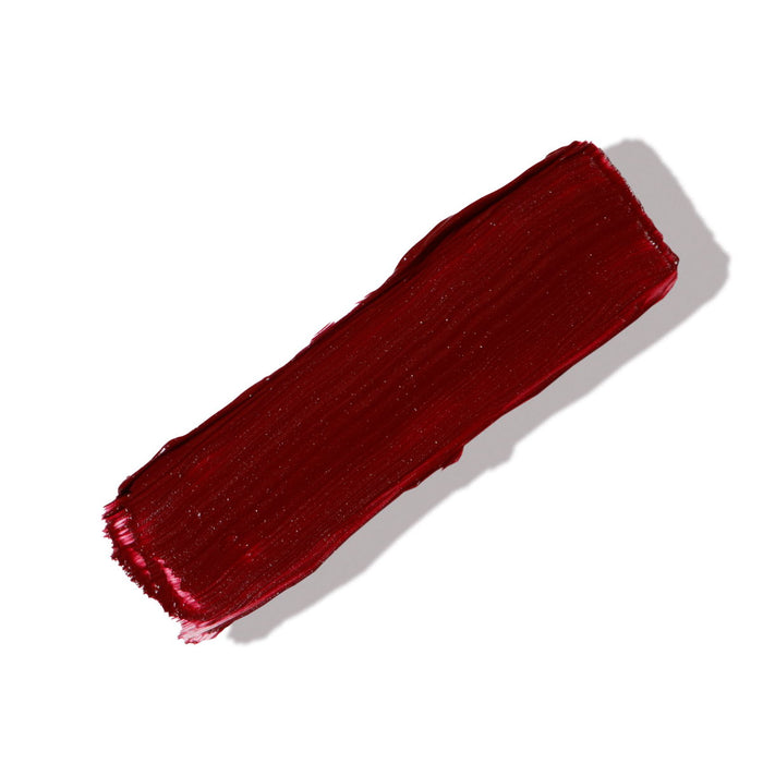 swatch of rd brown matte lipstick on white background