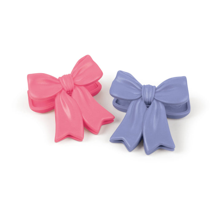 Set of four Fred & Friends Coquette Clips Bow Chip Clips on a neutral background, showcasing stylish kitchen bag clips.
