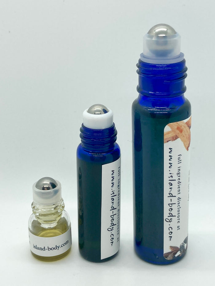 Three bottles of Creamy Coconut Lime essential oil perfume in 1ml, 5ml, and 10ml sizes displayed against a white background, showing the different blue glass roll-on container options.