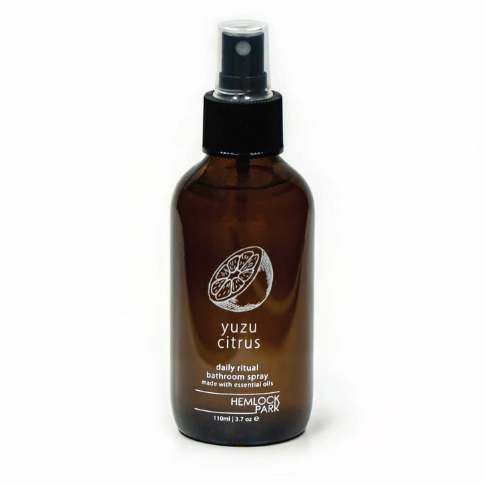 Room spray bottle with yuzu citrus label, amber glass, black mist nozzle and cap