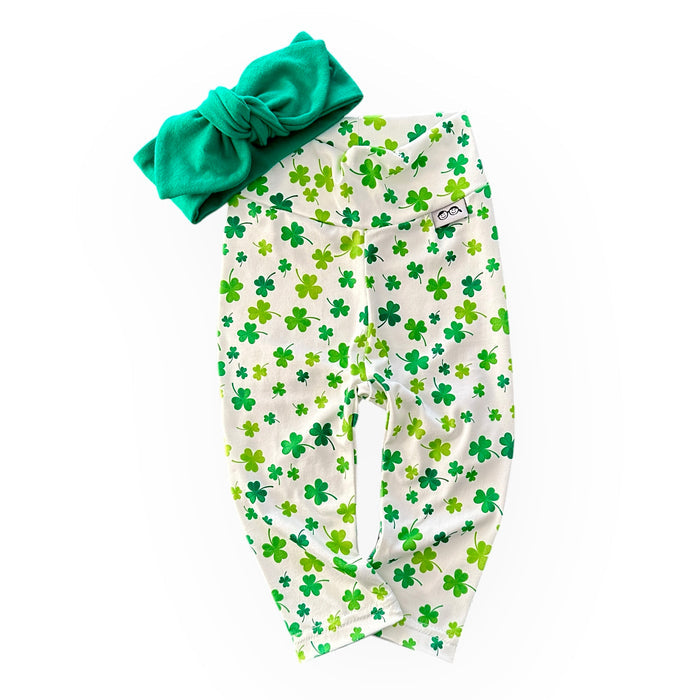 Festive green shamrock print leggings paired with a matching knotted headband, perfect for St. Patrick's Day celebrations or everyday wear. Handmade with soft, stretchy fabric for ultimate comfort and style. Available in sizes preemie to 4T, ideal for your little lucky charm!