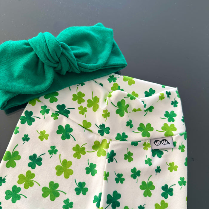 Festive green shamrock print leggings paired with a matching knotted headband, perfect for St. Patrick's Day celebrations or everyday wear. Handmade with soft, stretchy fabric for ultimate comfort and style. Available in sizes preemie to 4T, ideal for your little lucky charm!
