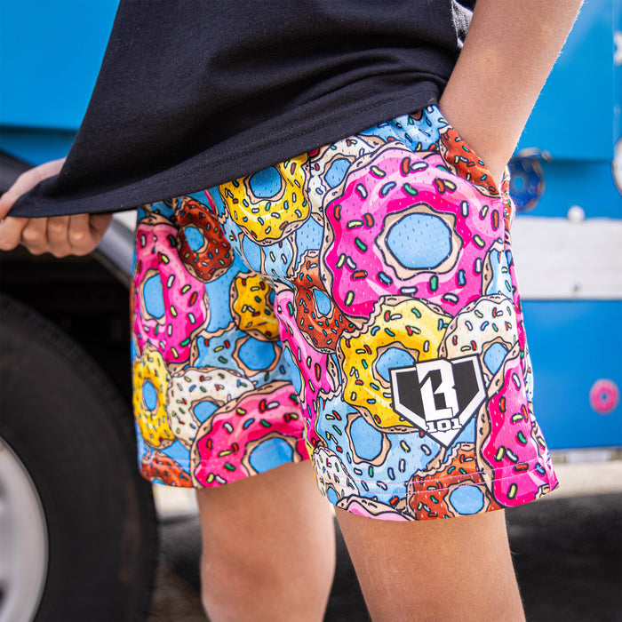 Youth model wearing multi-color Donut Assorted Flavors youth shorts