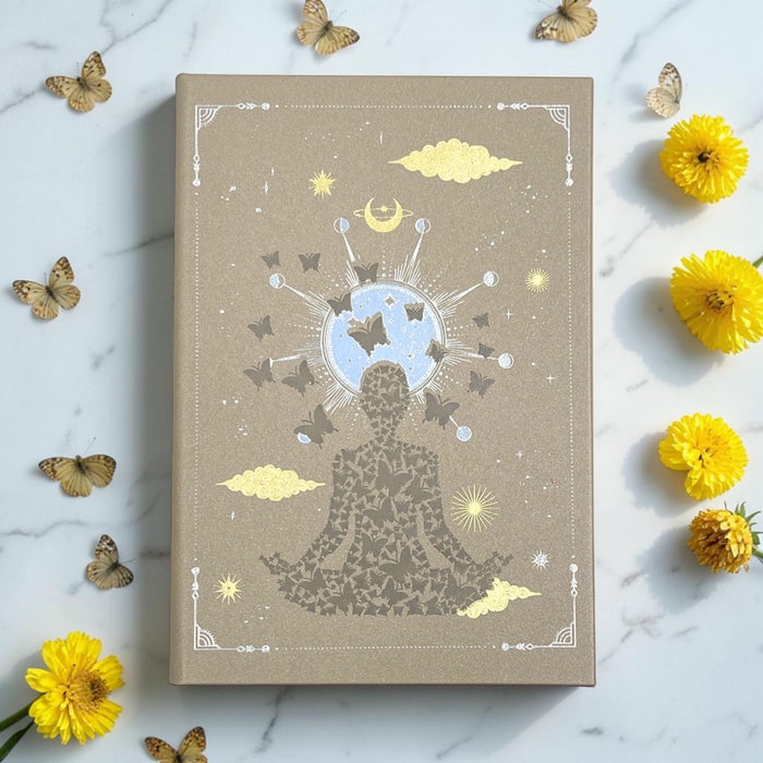 Earths Elements Intention Journal on a marble surface with flowers and butterflies.