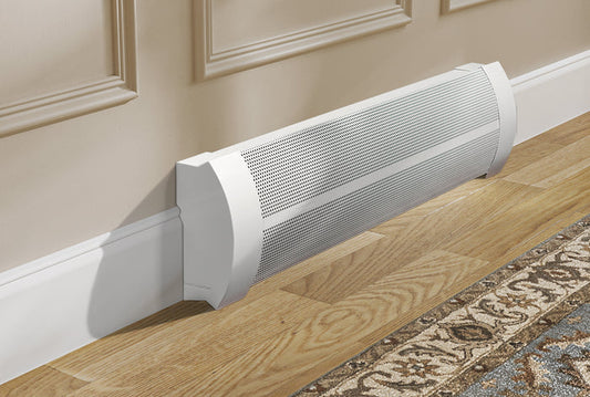 White Baseboarders Elliptus series slip-on baseboard heater cover featuring a sleek, curved perforated design, installed against a beige wall with picture frame molding above a hardwood floor