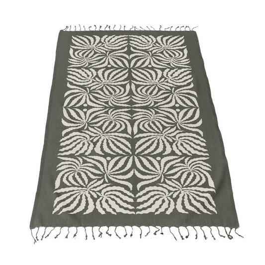 Dark gray Turkish towel blanket with light leaf pattern and fringed edges