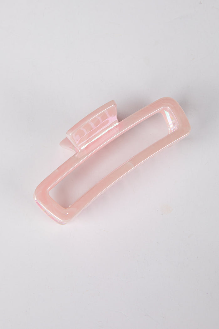 Pink hair clip on a light gray background