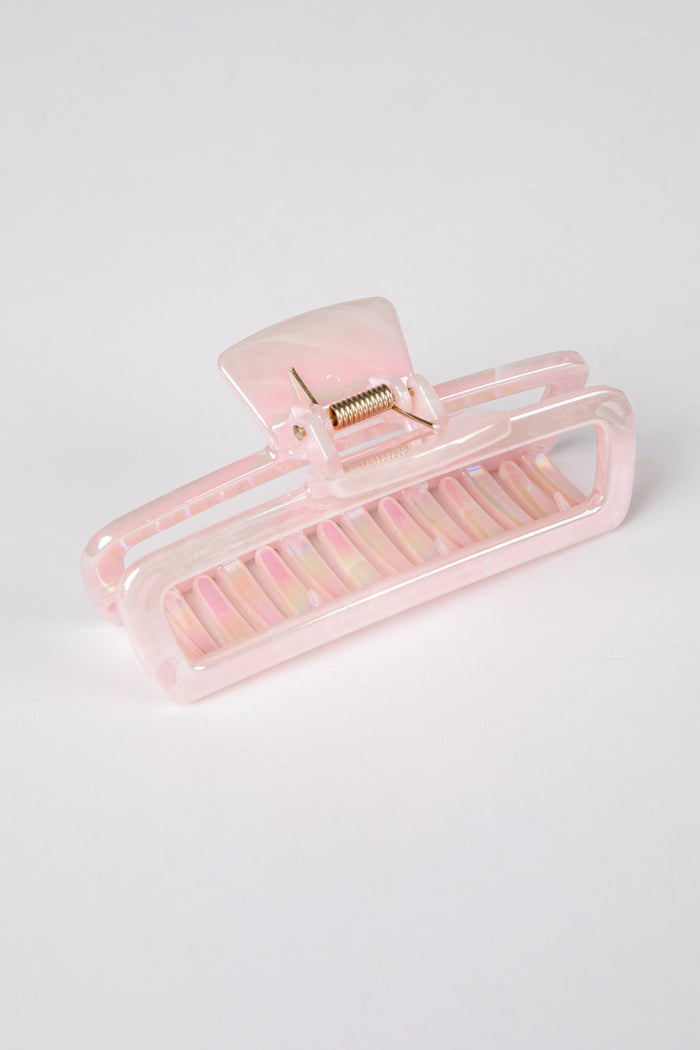 Pink hair clip on a light gray background