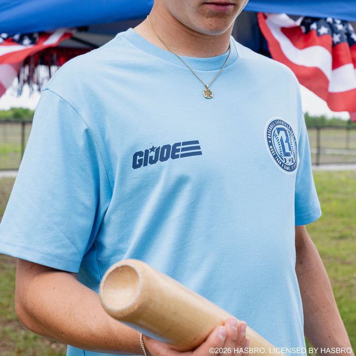 Close-up of adult male model in light blue GI Joe tee showing GI Joe and BL101 logos on chest while holding baseball bat