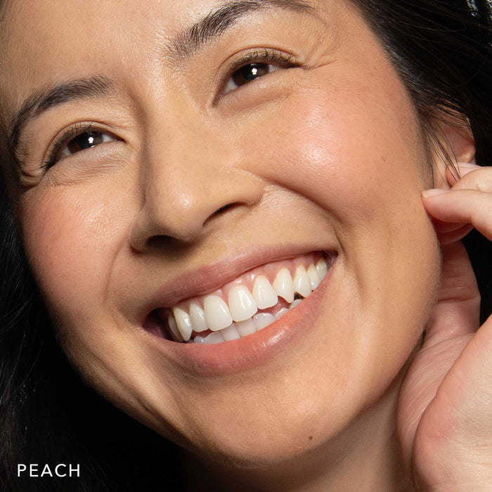 No Makeup Makeup – woman wearing peach blush on cheeks and lips, natural minimal makeup