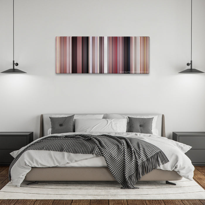 Grease color palette canvas above a bed, between two black pendant lamps