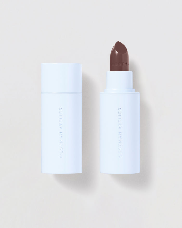 Brown lipstick on a beige background.
