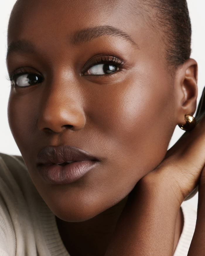 Close-up of a model wearing brown lipstick.