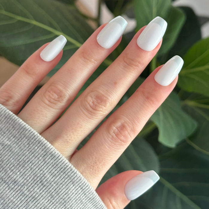 Icy Blue Velvet - Press On | Medium | Coffin nails with soft blue tonal polish and subtle glossy finish on hand against green leaves
