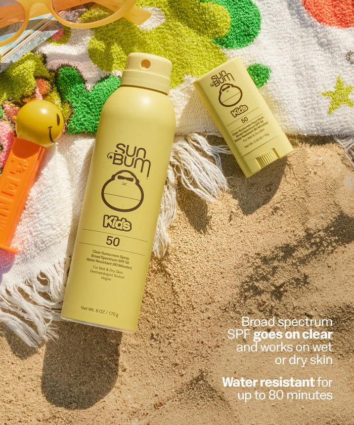 Sun Bum Kids sunscreen spray and stick on a sandy surface with beach toys. Broad spectrum
SPF goes on clear and works on wet or dry skin
Water resistant for up to 80 minutes.