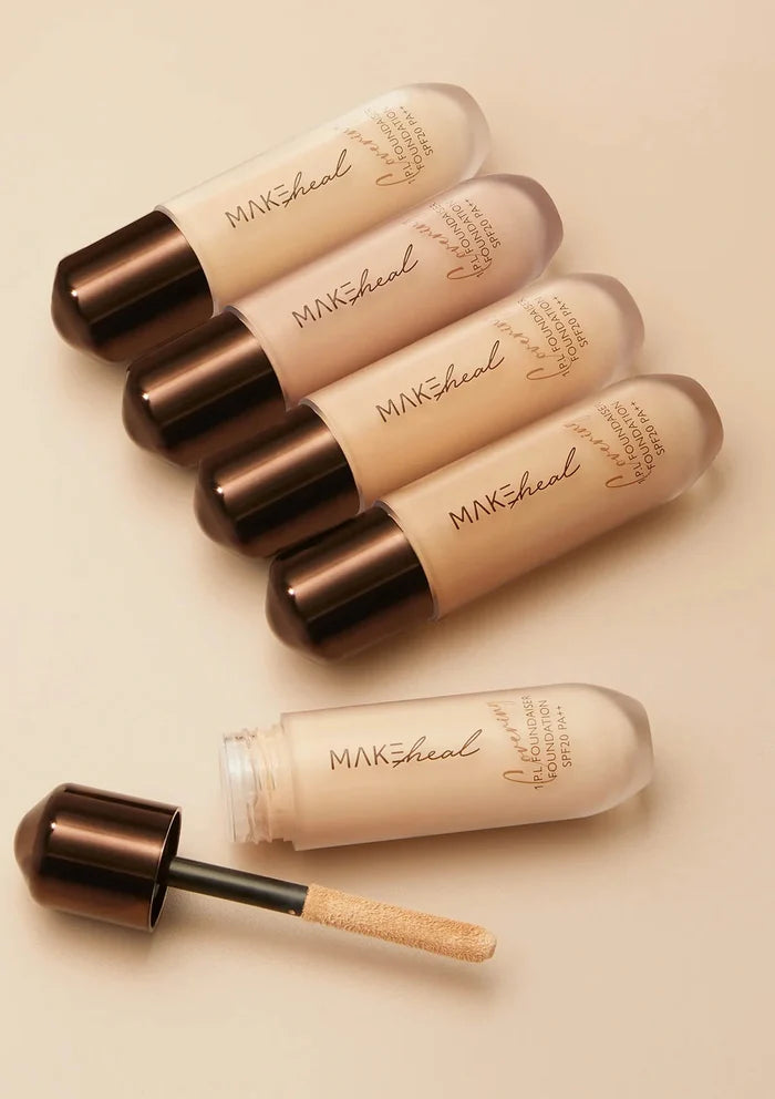 Set of MakSheld foundation bottles and a dropper on a beige background
