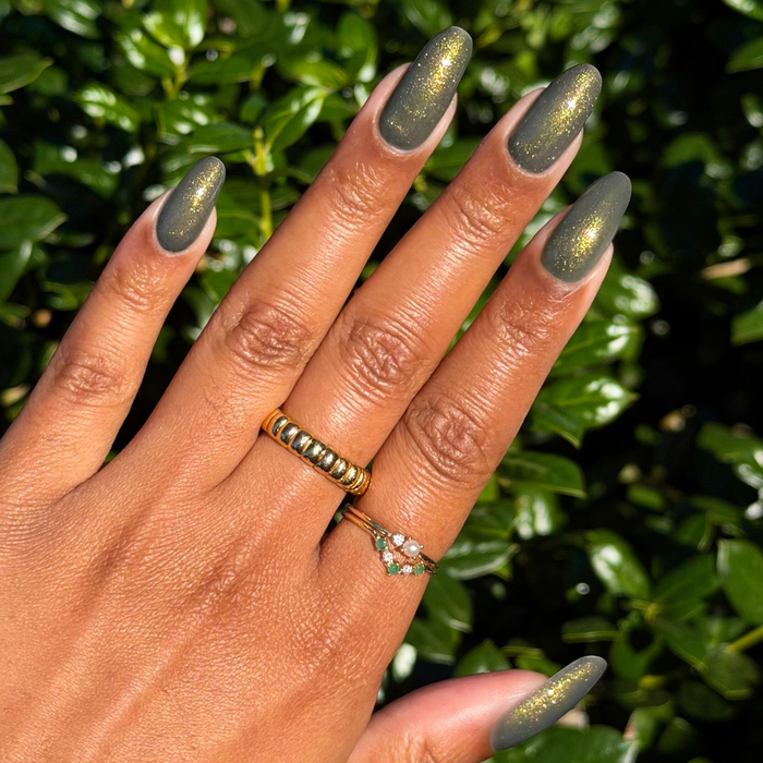 Martini Chrome Gel deep olive green with golden shimmer on long natural nails for a radiant at-home manicure