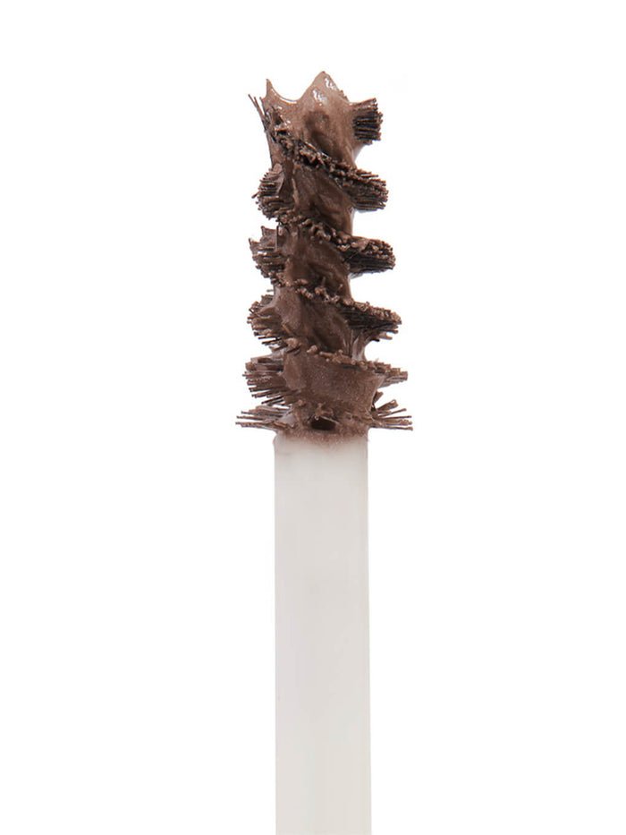 close up of mini unibrow tinted brow gel brush on white background