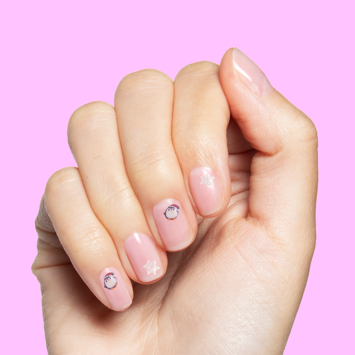 Paint & Play Slime + Nail Set showing hand with pastel pink quick dry polish and cute penguin and star nail art decals