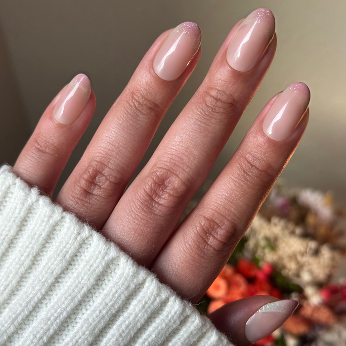 Party Glitter French - Press On | Medium | Oval with neutral base and subtle glitter french tips in medium oval shape manicure